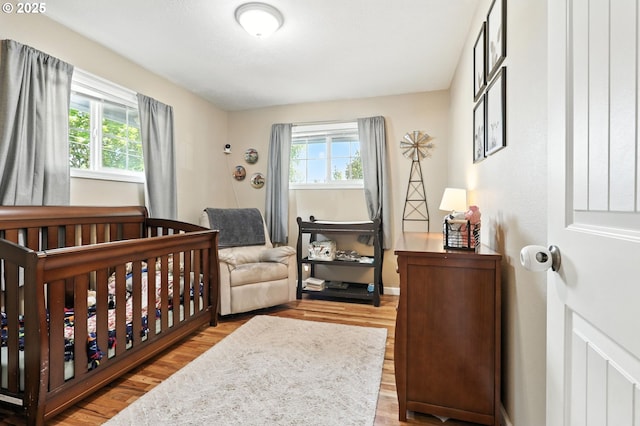 3216 Oakcrest Dr, Forest Grove, OR 97116 - bedroom with multiple windows, wood finished floors, and a crib