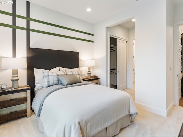 bedroom featuring light colored carpet and a closet