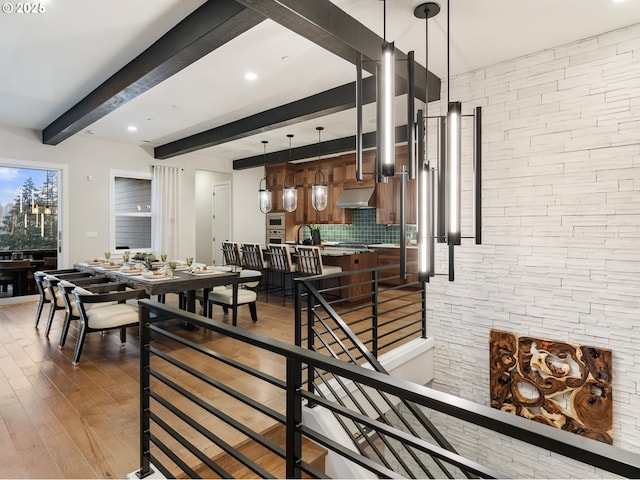 interior space with hardwood / wood-style floors and beam ceiling