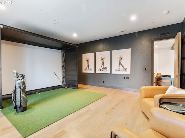 playroom with golf simulator and wood-type flooring