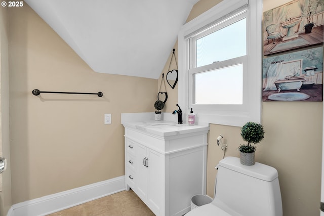 half bath featuring lofted ceiling, vanity, toilet, and baseboards