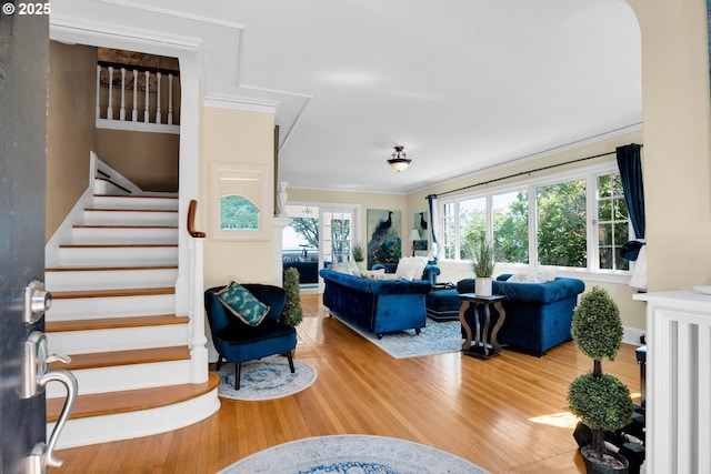 living room featuring stairway, wood finished floors, and ornamental molding