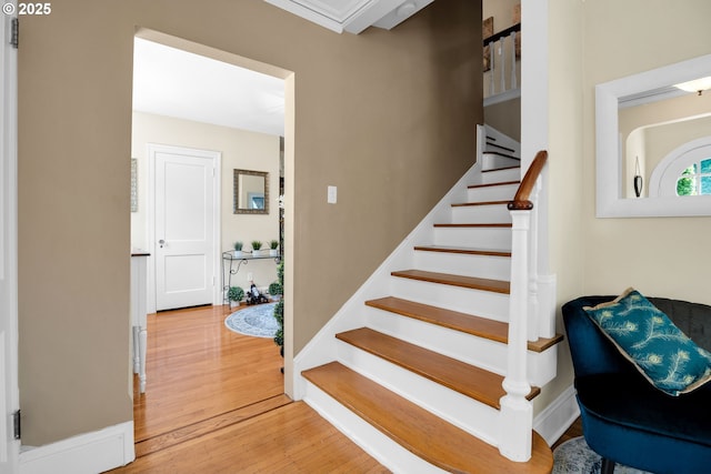 stairs with baseboards and wood finished floors