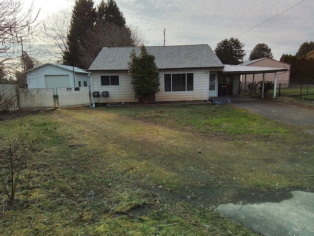 view of front of home featuring a carport, a front yard, and fence