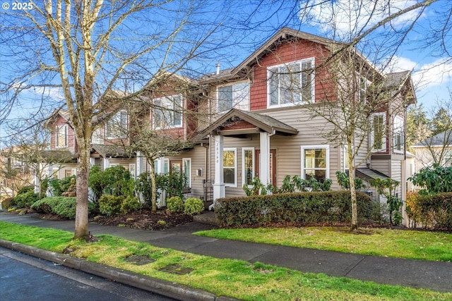 craftsman inspired home with a front yard