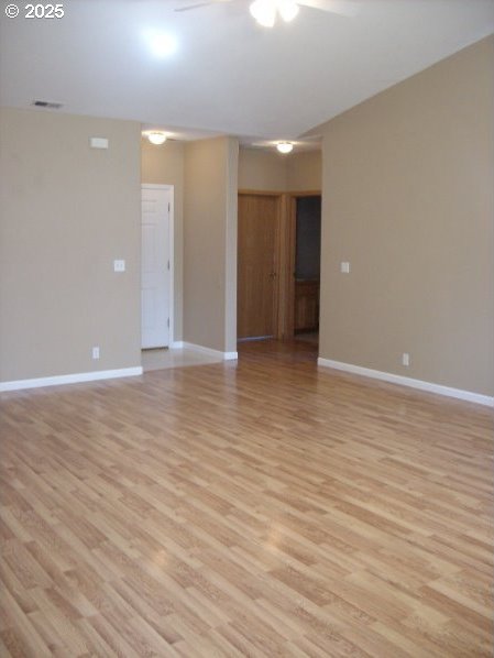 unfurnished room featuring ceiling fan and light hardwood / wood-style flooring