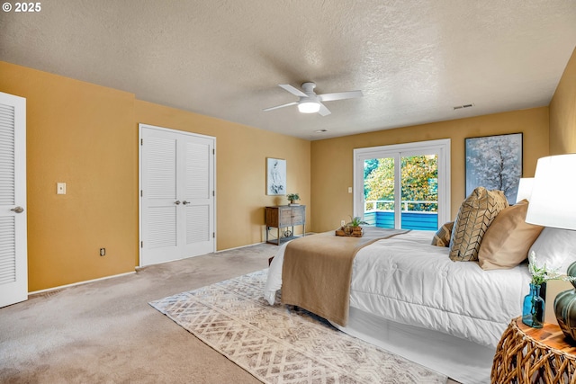 carpeted bedroom with access to outside, a textured ceiling, a ceiling fan, and baseboards
