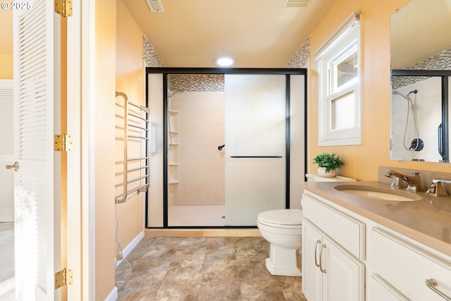 bathroom featuring a stall shower, toilet, vanity, radiator heating unit, and a closet