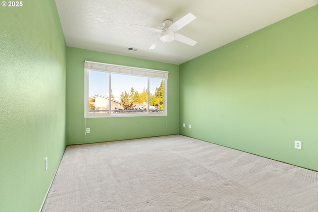 spare room featuring ceiling fan and carpet floors