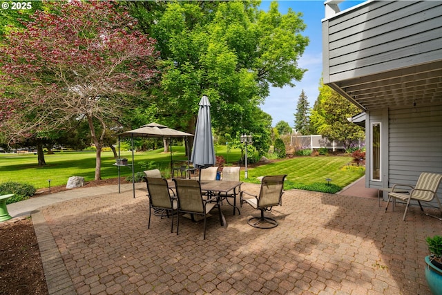 view of patio featuring a gazebo and outdoor dining space
