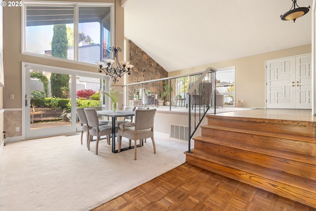 dining room featuring high vaulted ceiling, a chandelier, stairs, and baseboards