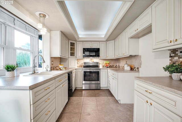 kitchen with black appliances, a sink, decorative backsplash, a raised ceiling, and light countertops