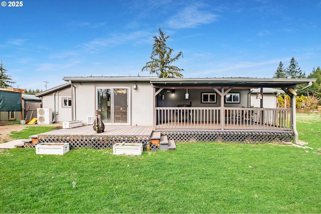 rear view of property featuring a deck and a lawn