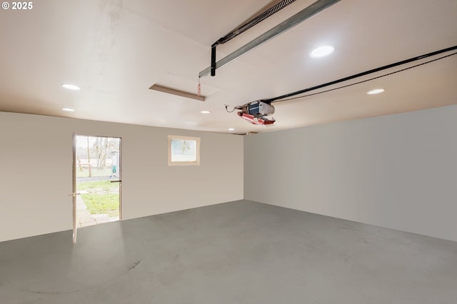 garage with recessed lighting and a garage door opener