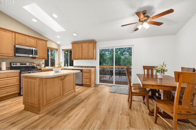 1573 SE 67th Ave, Hillsboro, OR 97123 - kitchen featuring stainless steel appliances, lofted ceiling, a skylight, light countertops, and plenty of natural light