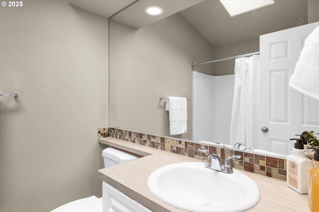 1573 SE 67th Ave, Hillsboro, OR 97123 - full bath featuring vanity, toilet, tasteful backsplash, and curtained shower