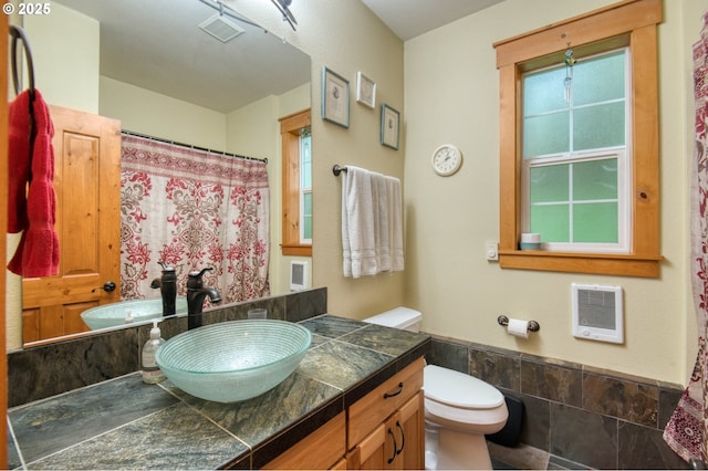 2064 NW 33rd St, Lincoln City, OR 97367 - full bath featuring toilet, vanity, heating unit, and a shower with shower curtain