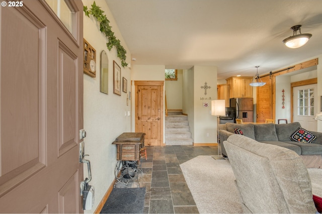 2064 NW 33rd St, Lincoln City, OR 97367 - living room with baseboards, stairway, and dark stone finish flooring