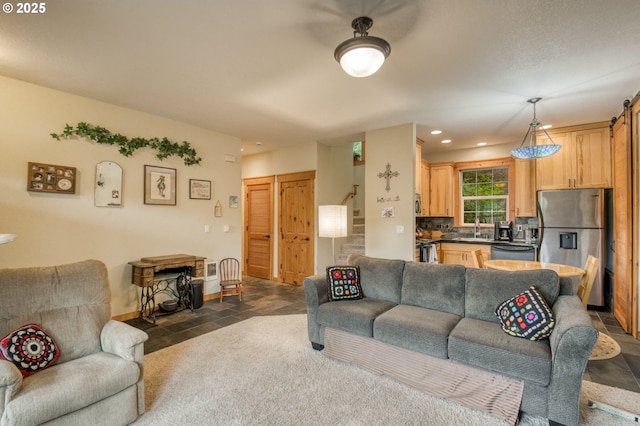 2064 NW 33rd St, Lincoln City, OR 97367 - living room featuring stone tile floors, recessed lighting, baseboards, and stairs