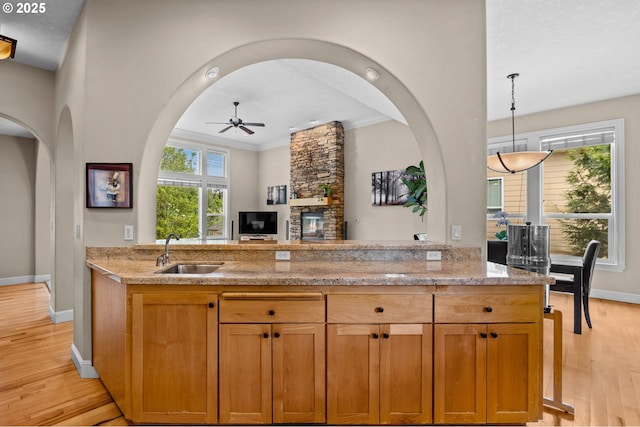 6420 SE Dunbar Dr, Portland, OR 97236 - kitchen with ceiling fan, light wood-type flooring, light stone counters, open floor plan, and ornamental molding