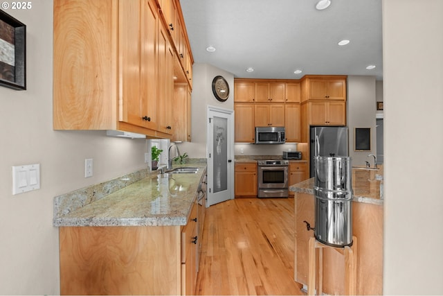 6420 SE Dunbar Dr, Portland, OR 97236 - kitchen with appliances with stainless steel finishes, light wood finished floors, recessed lighting, and light stone countertops