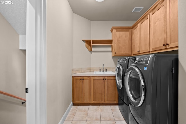 6420 SE Dunbar Dr, Portland, OR 97236 - laundry room featuring cabinet space, washer and dryer, and light tile patterned floors