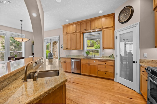 6420 SE Dunbar Dr, Portland, OR 97236 - kitchen with appliances with stainless steel finishes, healthy amount of natural light, light wood-type flooring, recessed lighting, and light stone countertops