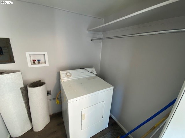 681 SE Neptune Ave, Lincoln City, OR 97367 - laundry room with washer / dryer, electric panel, and dark wood-style flooring
