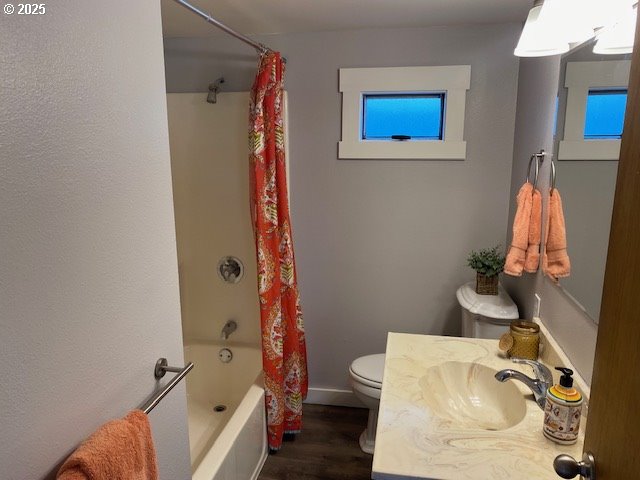 681 SE Neptune Ave, Lincoln City, OR 97367 - bathroom featuring toilet, wood finished floors, shower / bath combination with curtain, and vanity