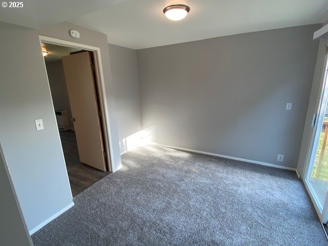 681 SE Neptune Ave, Lincoln City, OR 97367 - carpeted empty room featuring baseboards and a smoke detector