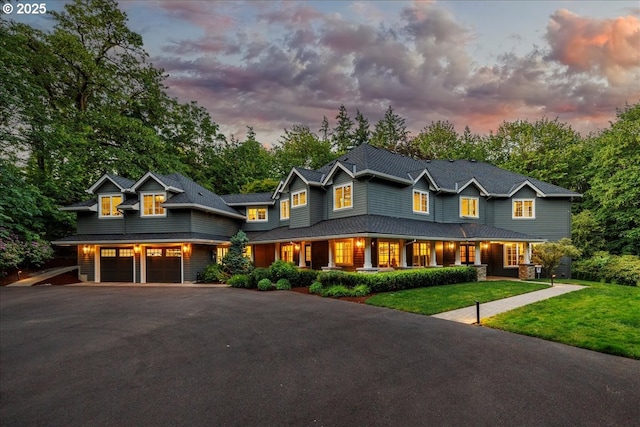 1051 Forest Meadows Way, Lake Oswego, OR 97034 - view of front facade with asphalt driveway, covered porch, a lawn, and an attached garage