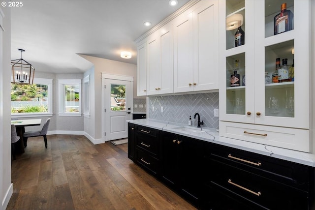 1051 Forest Meadows Way, Lake Oswego, OR 97034 - kitchen with a sink, dark cabinets, baseboards, white cabinets, and a chandelier