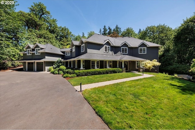 1051 Forest Meadows Way, Lake Oswego, OR 97034 - view of front of house with an attached garage, asphalt driveway, a front lawn, a porch, and a chimney