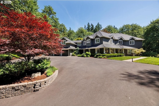 1051 Forest Meadows Way, Lake Oswego, OR 97034 - view of front of house with an attached garage, asphalt driveway, and a front yard