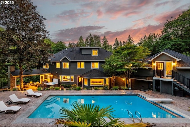 1051 Forest Meadows Way, Lake Oswego, OR 97034 - pool at dusk featuring an outdoor pool, a patio, a diving board, and stairway