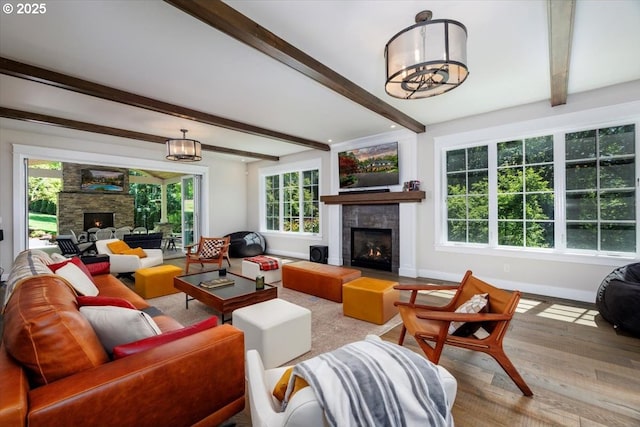 1051 Forest Meadows Way, Lake Oswego, OR 97034 - living room with a lit fireplace, wood finished floors, beamed ceiling, baseboards, and a chandelier