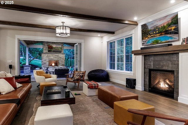 1051 Forest Meadows Way, Lake Oswego, OR 97034 - living area featuring a lit fireplace, wood finished floors, beamed ceiling, and baseboards