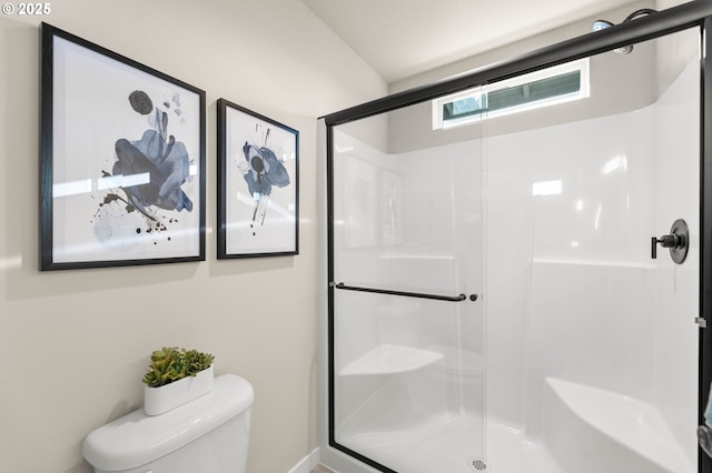 bathroom featuring an enclosed shower and toilet