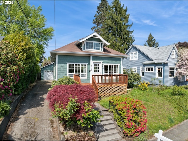 2055 N Alberta St, Portland, OR 97217 - bungalow featuring a garage, an outbuilding, and a wooden deck