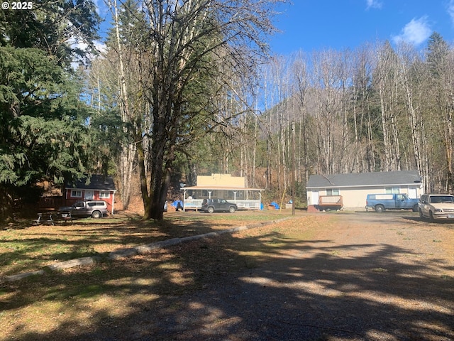 view of yard featuring a view of trees