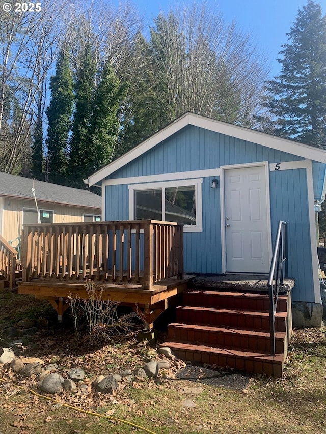 back of house featuring a wooden deck