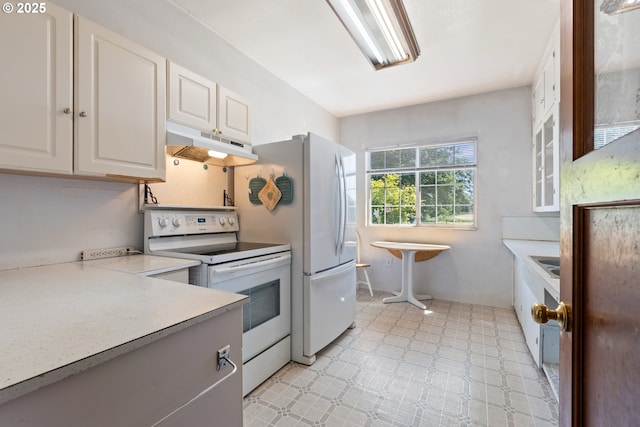 2170 Hubbard Creek Rd, Umpqua, OR 97486 - kitchen featuring under cabinet range hood, white electric range, light countertops, and white cabinetry