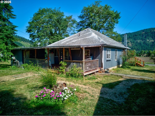 2170 Hubbard Creek Rd, Umpqua, OR 97486 - rear view of property featuring a shingled roof, covered porch, and a lawn