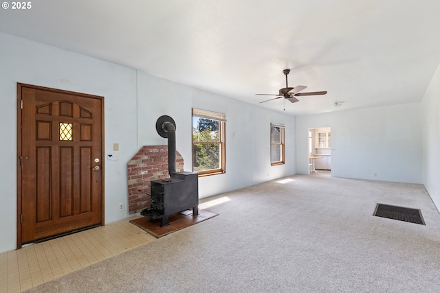 2170 Hubbard Creek Rd, Umpqua, OR 97486 - unfurnished living room featuring ceiling fan, a wood stove, and carpet
