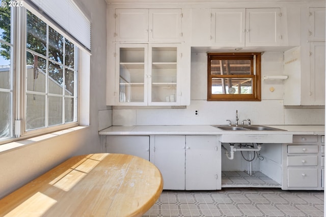 2170 Hubbard Creek Rd, Umpqua, OR 97486 - kitchen with a sink, healthy amount of natural light, light countertops, and white cabinetry
