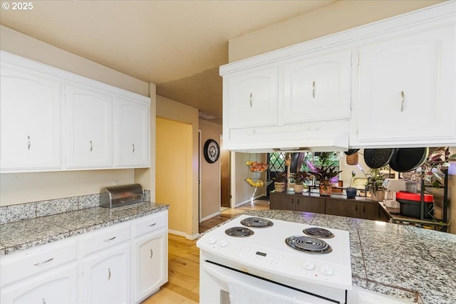5770 SW Cranberry Ct, Beaverton, OR 97007 - kitchen with white range with electric cooktop, white cabinetry, light wood-style floors, and baseboards