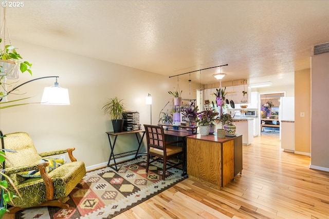 5770 SW Cranberry Ct, Beaverton, OR 97007 - office with light wood-style flooring, a textured ceiling, and baseboards