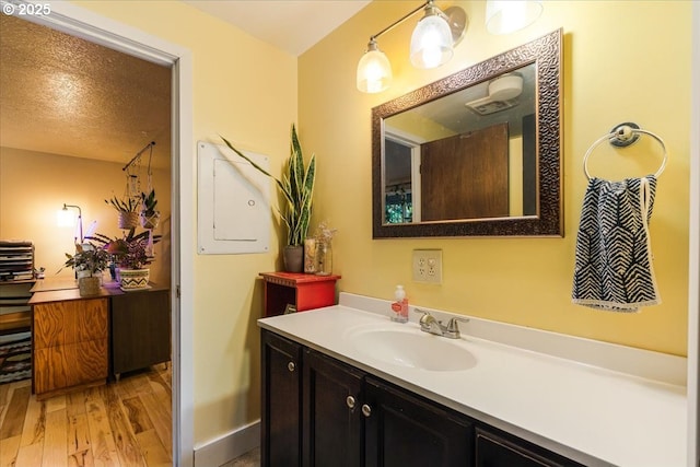 5770 SW Cranberry Ct, Beaverton, OR 97007 - bathroom with vanity, wood finished floors, and baseboards