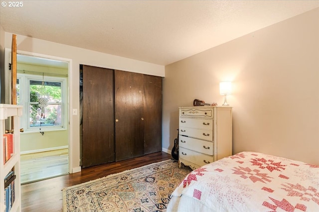 5770 SW Cranberry Ct, Beaverton, OR 97007 - bedroom featuring wood finished floors, a closet, and baseboards