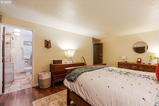 5770 SW Cranberry Ct, Beaverton, OR 97007 - bedroom with wood finished floors, ensuite bathroom, and a textured ceiling
